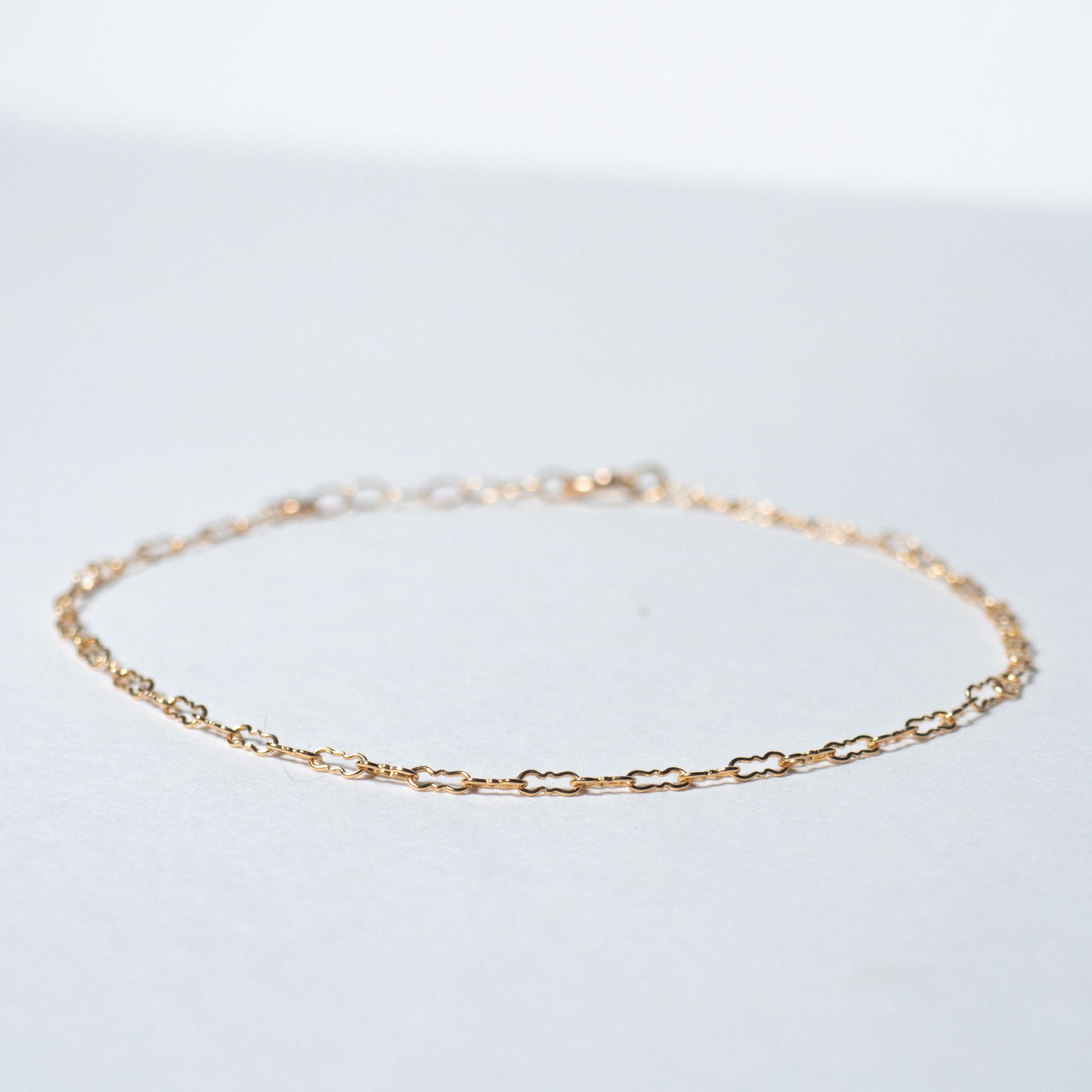 Dainty gold filled Crinkle chain bracelet on white background. 